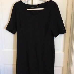 A black plain dress with short sleeves and a zip